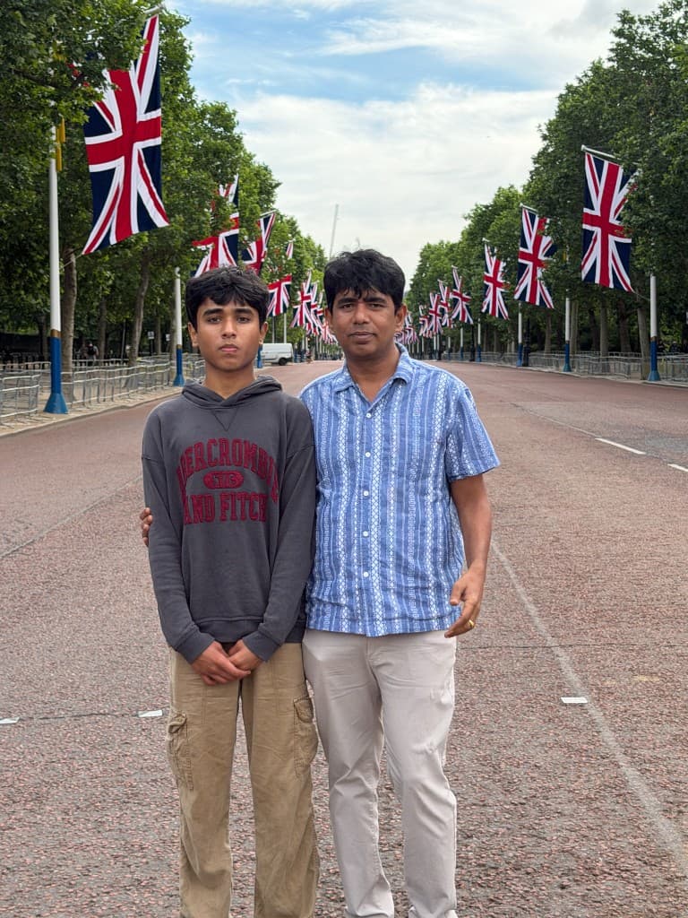 Sudhith Mannuru standing with Rama Mannuru on a tree-lined boulevard in London.